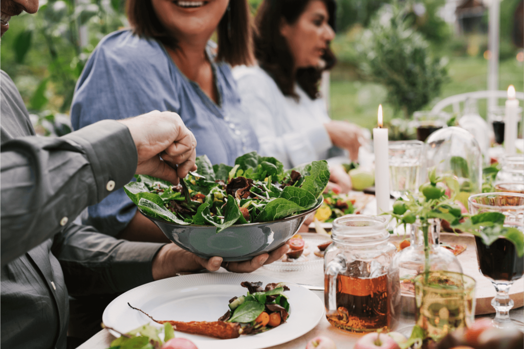 Outdoor dinner party with salad bowl