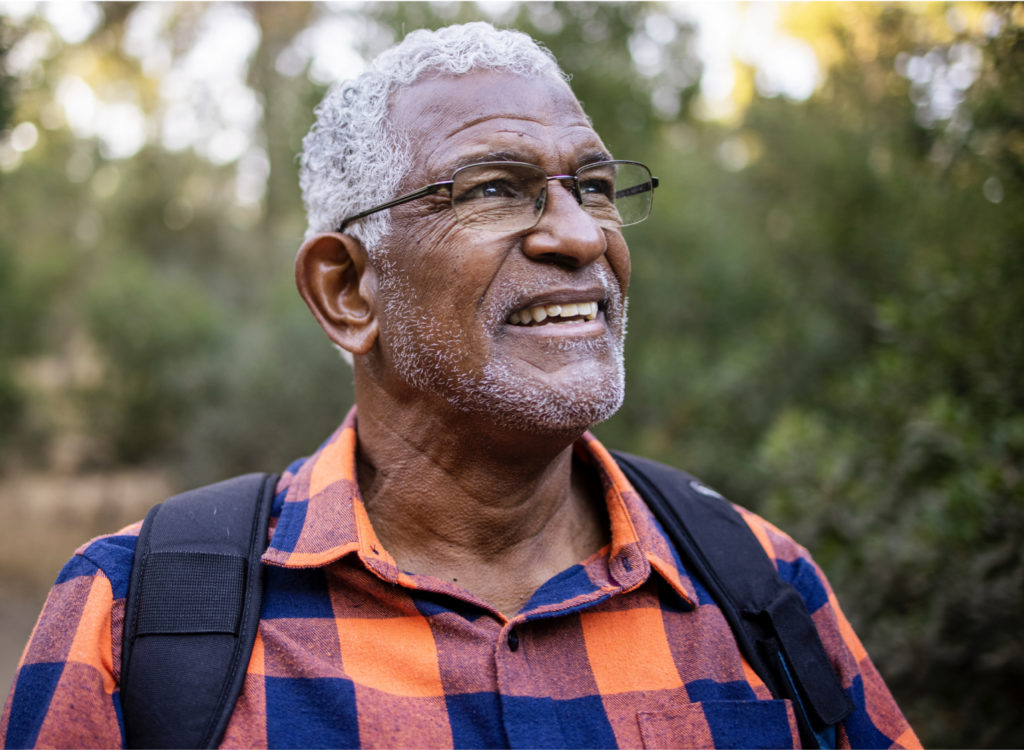 Elderly male with backpack somewhere in nature