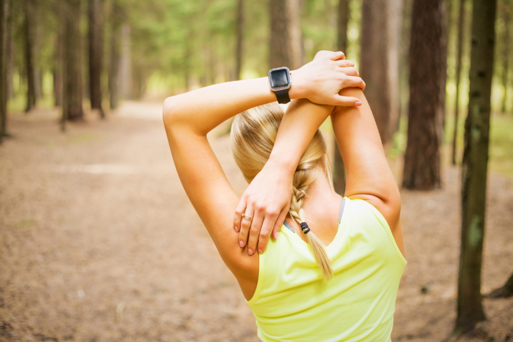 Woman stretching in the woods