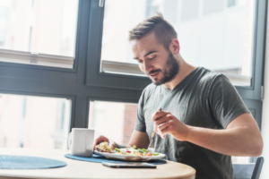 Man eating healthy meal at table