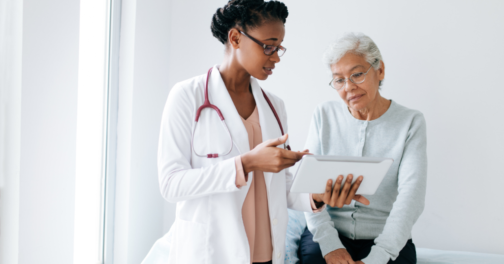 Provider with individual looking at tablet.