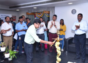 An employee lights a candle in front of a group of colleagues at a celebration event in our Bangalore office.