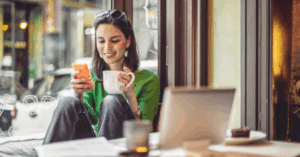 Woman on phone drinking coffee