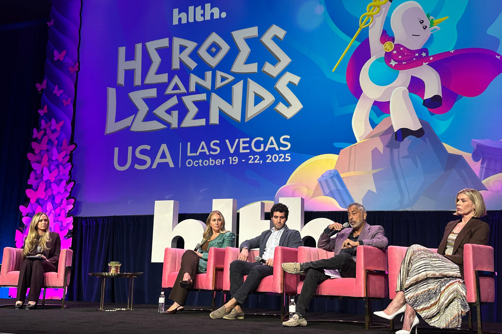 Homepage Anand Iyer speaking on stage at HLTH.